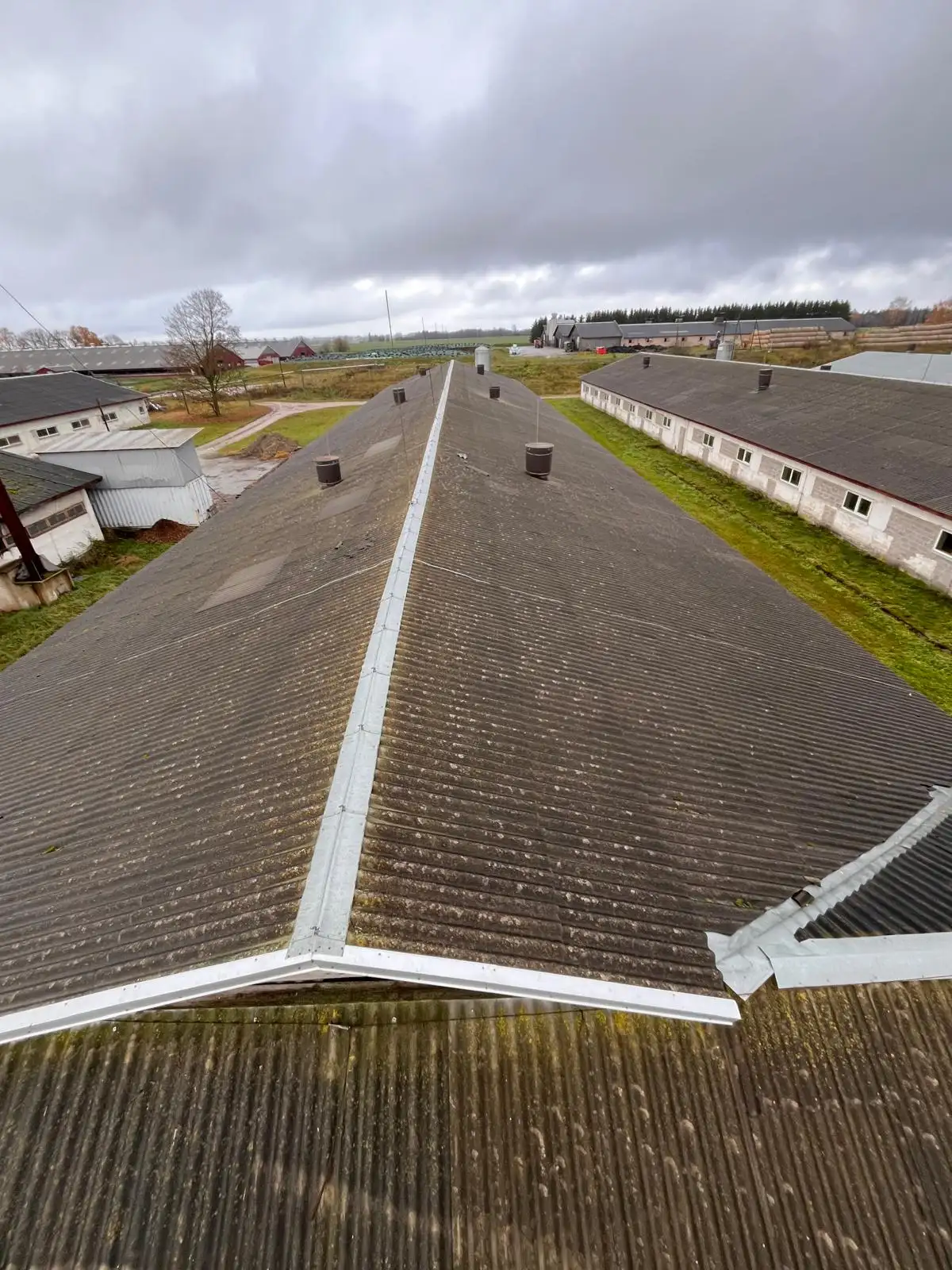 Large farm roof cleaned of moss with new ridge and verge flashing