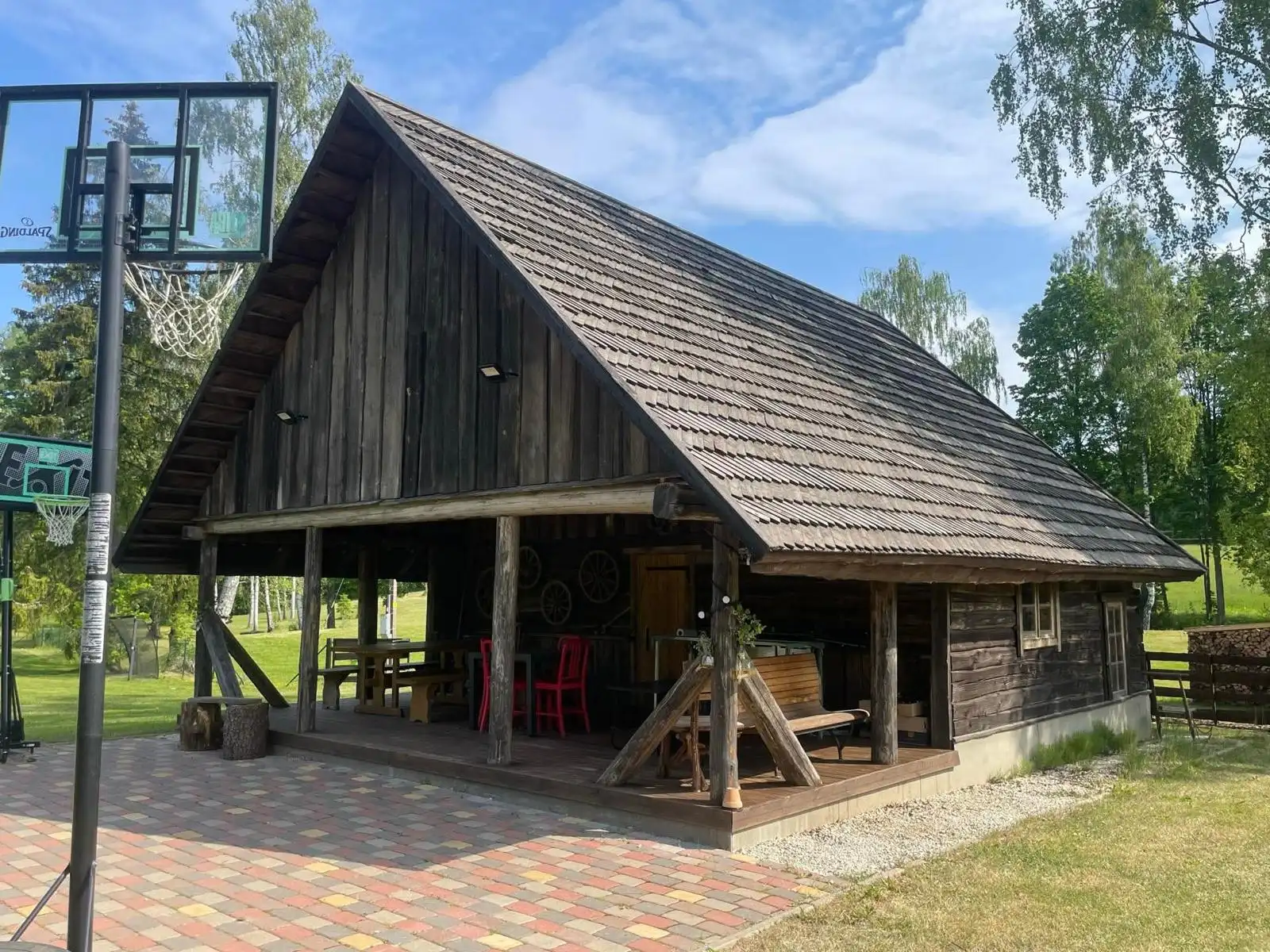 Restored granary with shingle roof and open terrace on posts